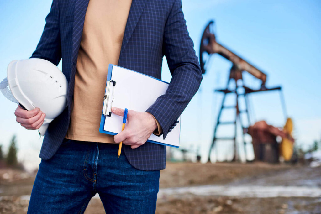 Cropped Snapshot Inspector Oil Field Holding Folder Notes Helmet Scaled