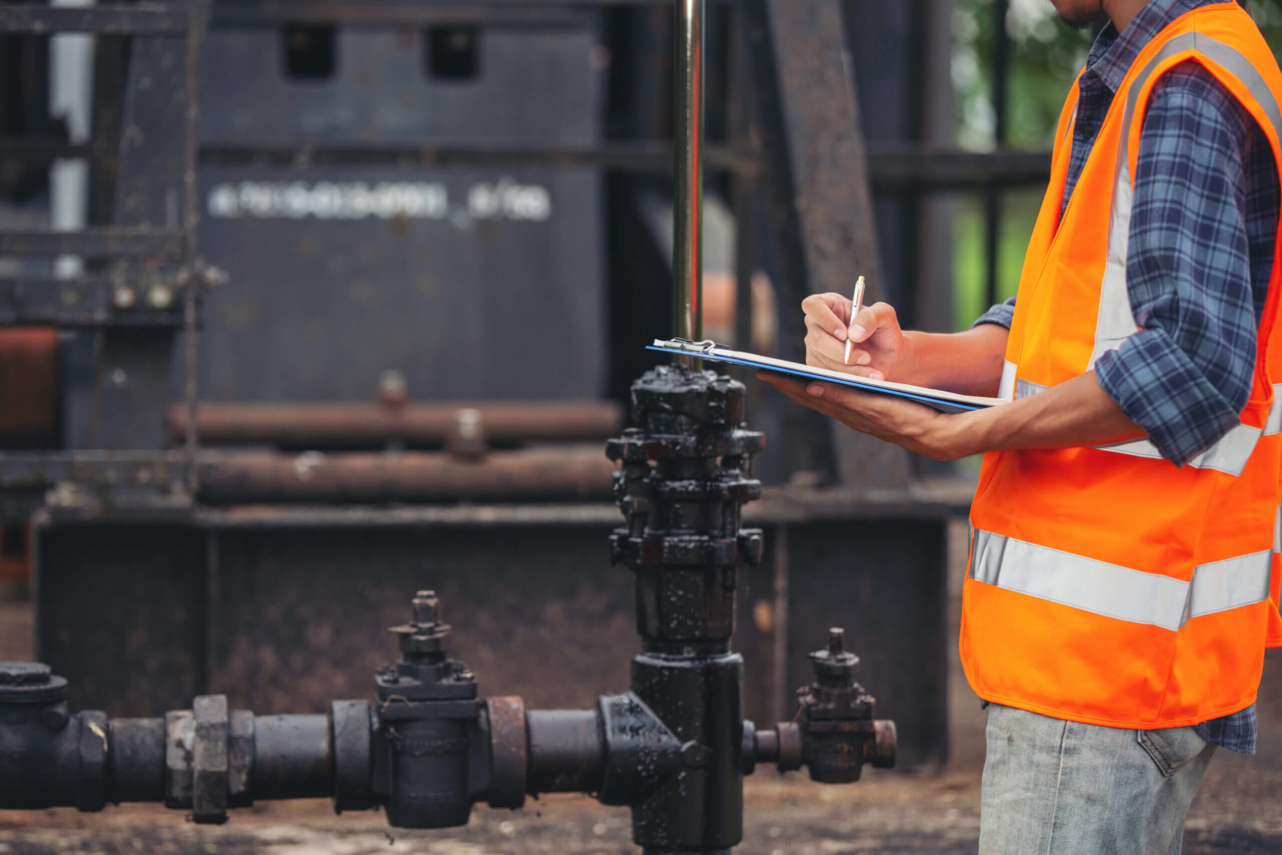 Workers Standing Checking Beside Working Oil Pumps Scaled